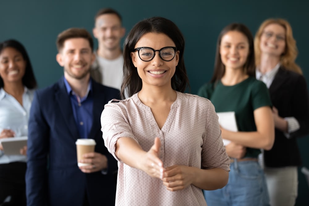 Mixed,Race,Woman,Sales,Manager,Stretch,Out,Hand,Introduces,Herself